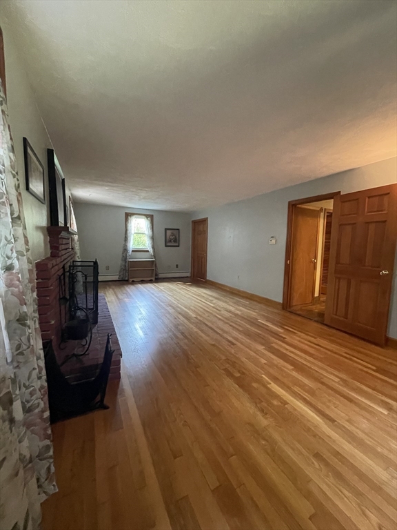 7 Albert Street Billerica, MA 01821 - Photo 16 of 33 a bedroom with furniture and wooden floor