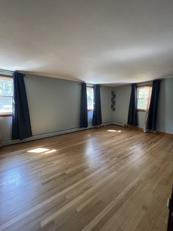 7 Albert Street Billerica, MA 01821 - Photo 18 of 33 an empty room with wooden floor and windows