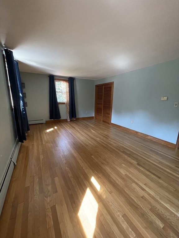 7 Albert Street Billerica, MA 01821 - Photo 19 of 33 wooden floor in an empty room with a window
