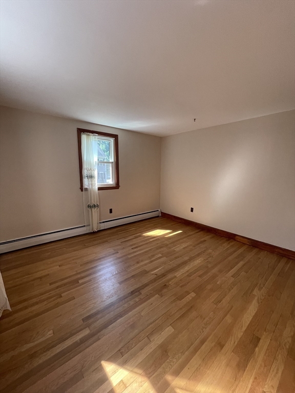 7 Albert Street Billerica, MA 01821 - Photo 21 of 33 a view of empty room with wooden floor and fan