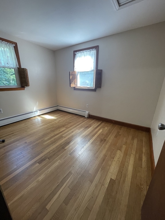 7 Albert Street Billerica, MA 01821 - Photo 23 of 33 a view of an empty room with wooden floor and a window