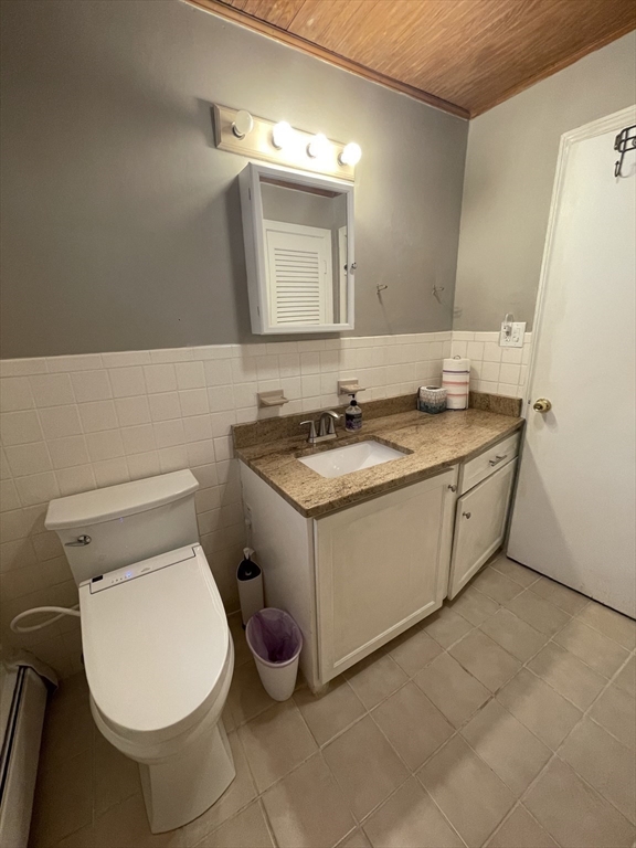 7 Albert Street Billerica, MA 01821 - Photo 27 of 33 a bathroom with a granite countertop toilet sink and mirror