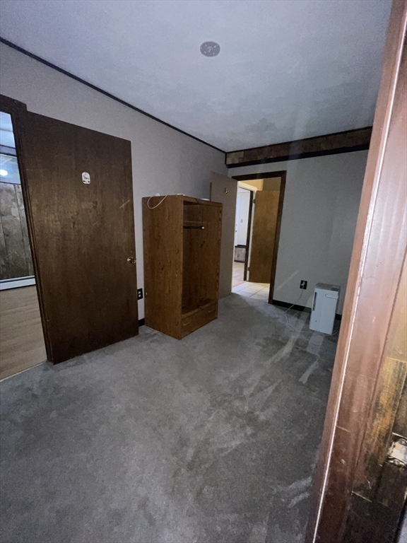 7 Albert Street Billerica, MA 01821 - Photo 32 of 33 an empty room with closet and wooden door