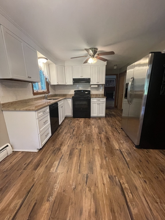 7 Albert Street Billerica, MA 01821 - Photo 9 of 33 a kitchen with granite countertop a sink cabinets and stainless steel appliances