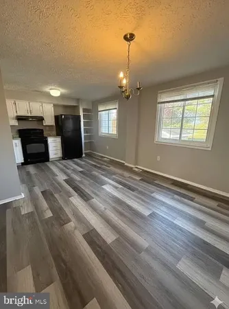 a view of an empty room with window and fireplace
