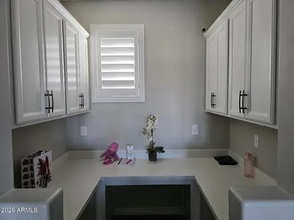 a kitchen with a sink cabinets and a window