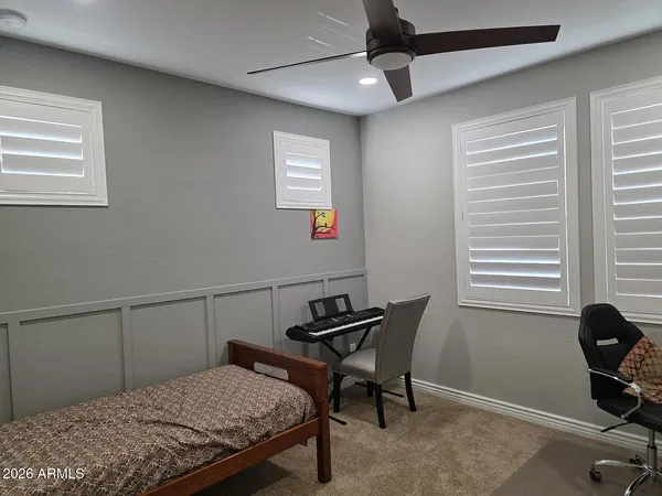 a bedroom that has a bed and a chair in it