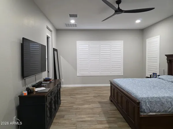 a bathroom with a granite countertop sink a mirror and a bathtub