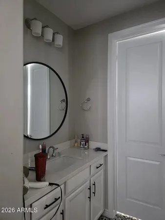 a bathroom with a granite countertop sink and a mirror