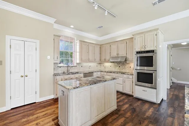a kitchen with a stove and a sink