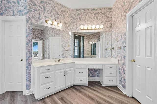 a spacious bathroom with a granite countertop sink mirror and a shower