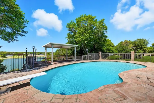 a view of a house with swimming pool and porch