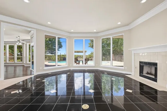 a living room with a large window and a fireplace