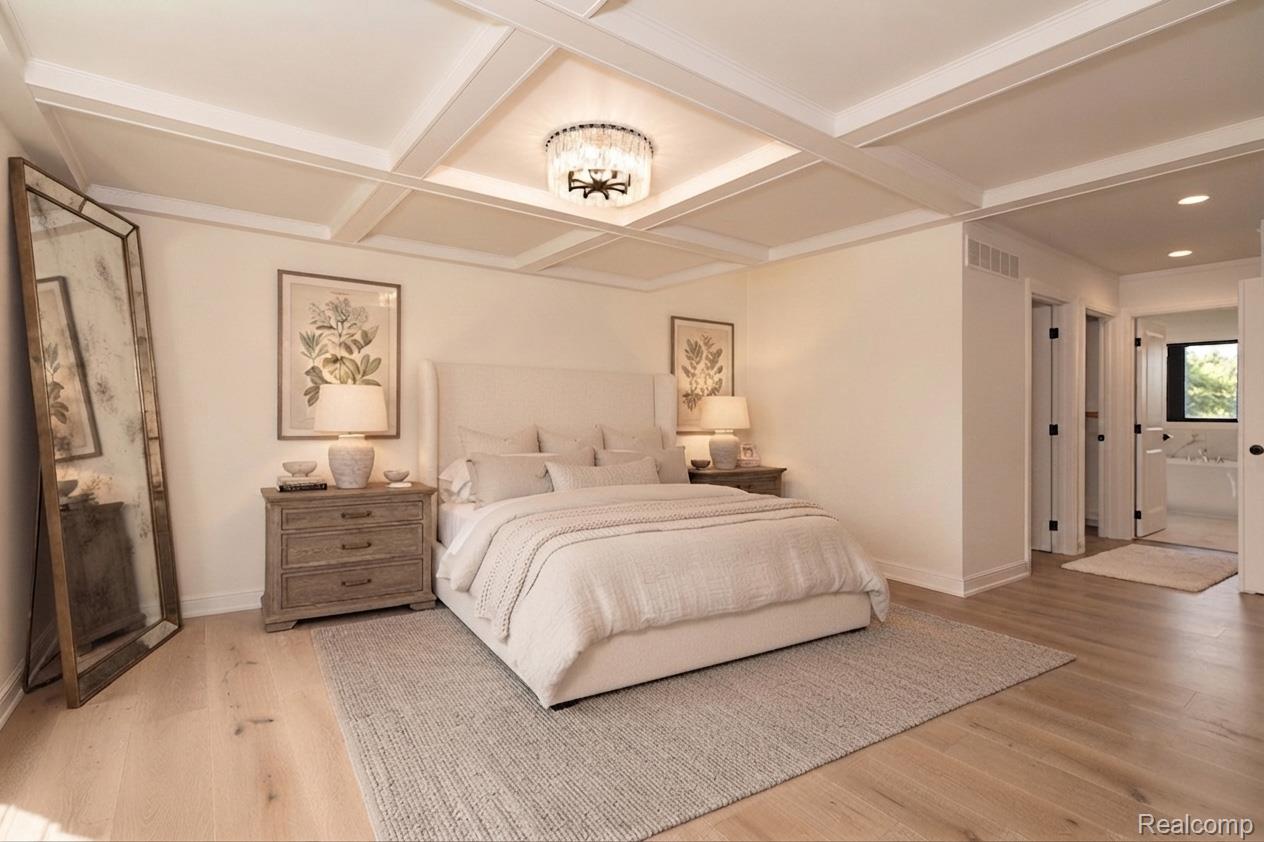 3836 Coachwood Lane Rochester, MI 48309 - Photo 26 of 82 Sophisticated primary bedroom showcasing a coffered ceiling with recessed lighting, light wood-finish flooring throughout, and a neutral color palette