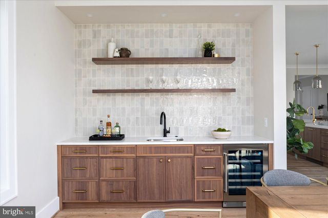 a kitchen with granite countertop a sink and cabinets