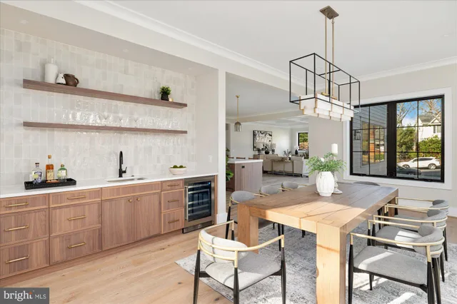 a living room with couches a large mirror with wooden floor
