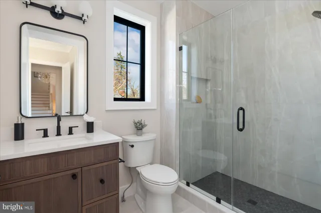 a spacious bedroom with a bed couch and windows