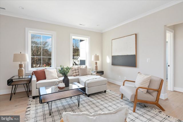 a living room with furniture and floor to ceiling windows