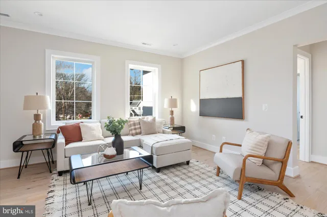 a living room with furniture and floor to ceiling windows