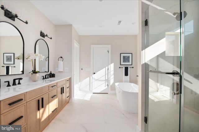 a bathroom with a toilet sink vanity and mirror