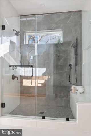 a bathroom with a granite countertop sink vanity mirror and shower