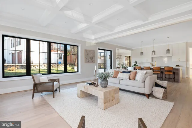 a kitchen with stainless steel appliances a dining table chairs and white cabinets