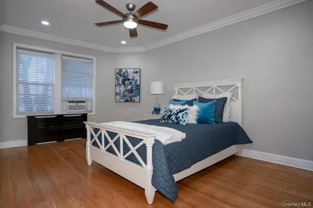 a bed sitting in a spacious bedroom next to a window