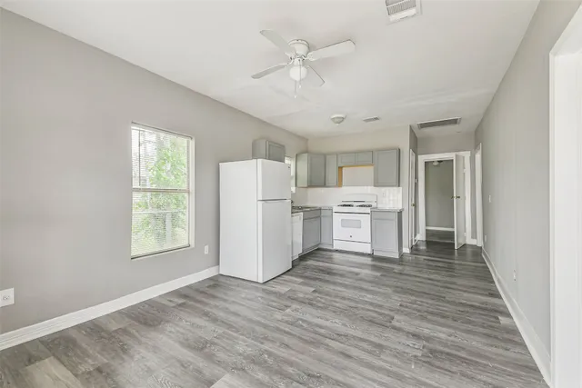 a view of a kitchen with wooden floor and a kitchen