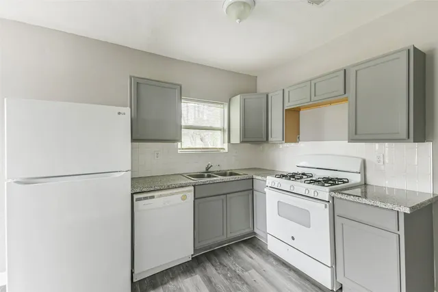 a kitchen with a stove a sink and a refrigerator