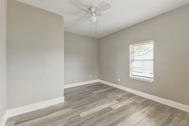 wooden floor in an empty room with a window