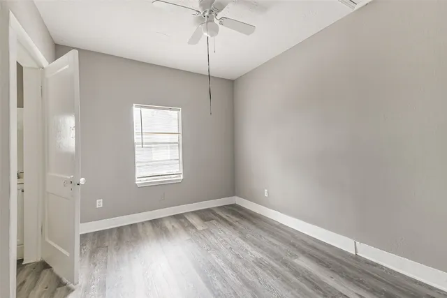 wooden floor in an empty room with a window