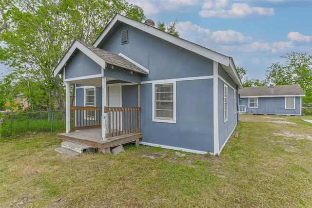 a backyard of a house with a garden and deck