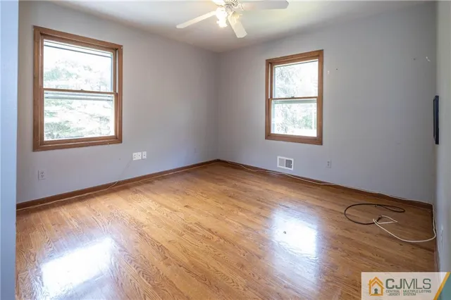 a kitchen with a refrigerator a sink cabinets and wooden floor