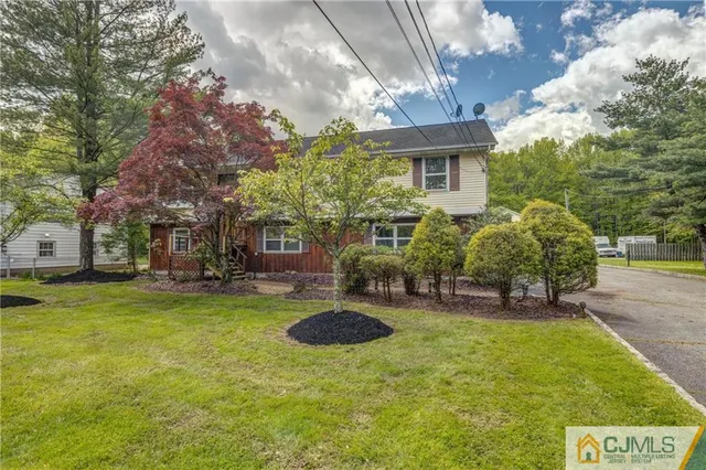 a view of a house with backyard porch and sitting area