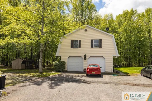 an aerial view of a house with a yard and garden