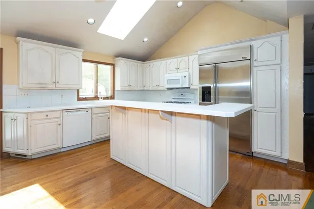 a kitchen with a sink cabinets and wooden floor
