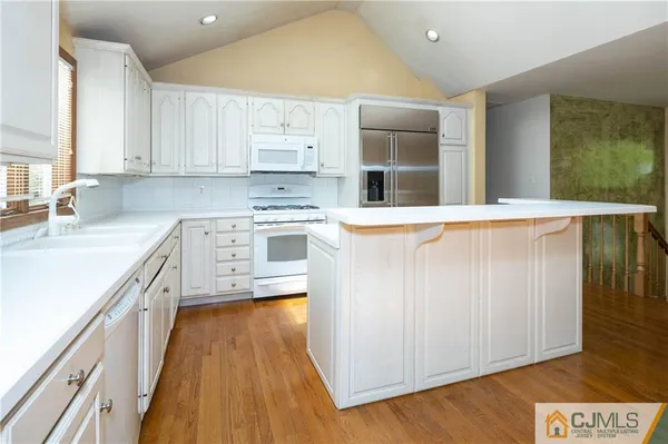 a kitchen with stainless steel appliances a sink and a stove top oven