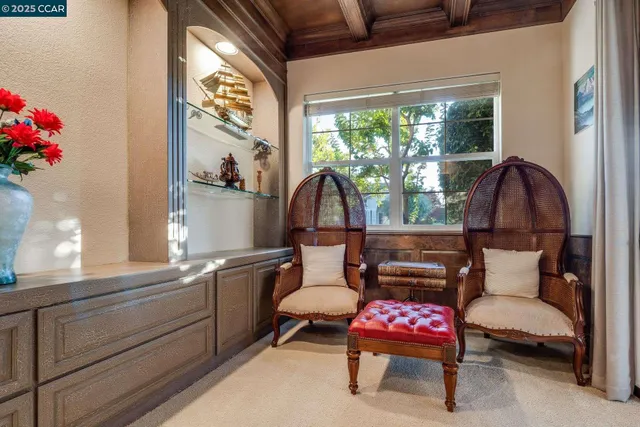 a dining room with furniture a chandelier and wooden floor