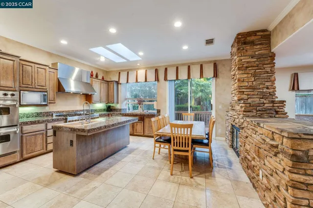 a kitchen with center island table and chairs