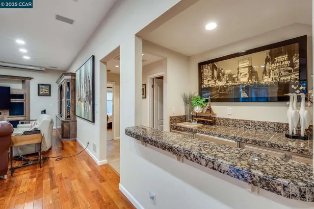 a kitchen with granite countertop a sink and a stove
