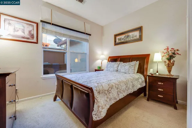 a bedroom with a granite countertop sink and vanity