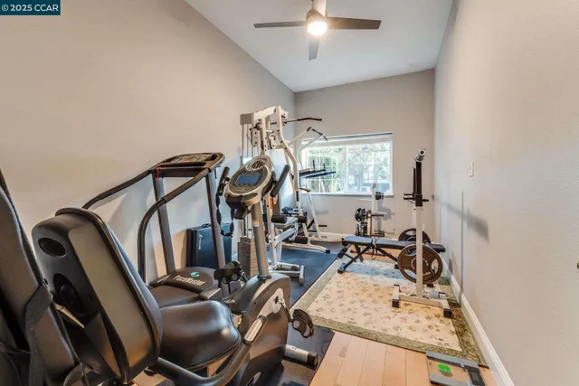 a view of staircase with lots of frames on wall and a window