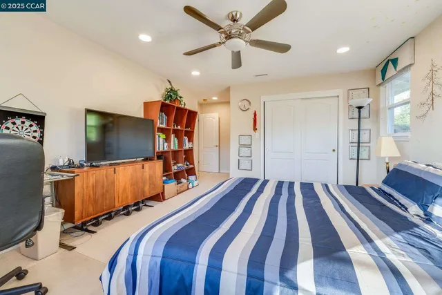 a spacious bedroom with a bed and a fireplace