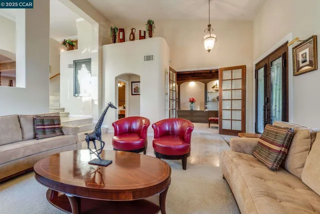 a living room with furniture a fireplace and a large window