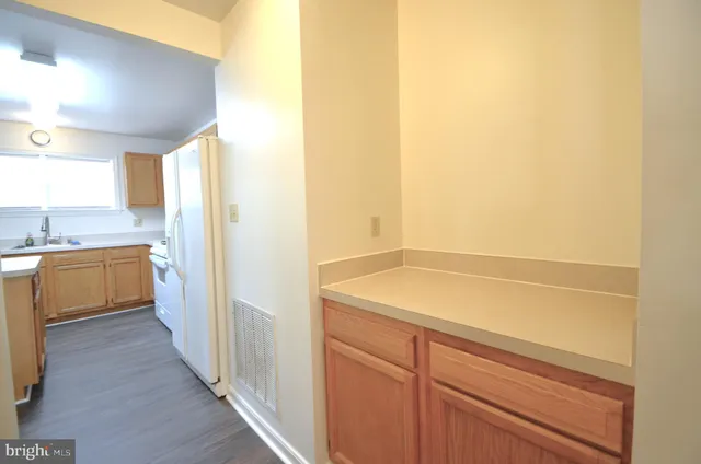 a kitchen with a sink a counter top space and cabinets