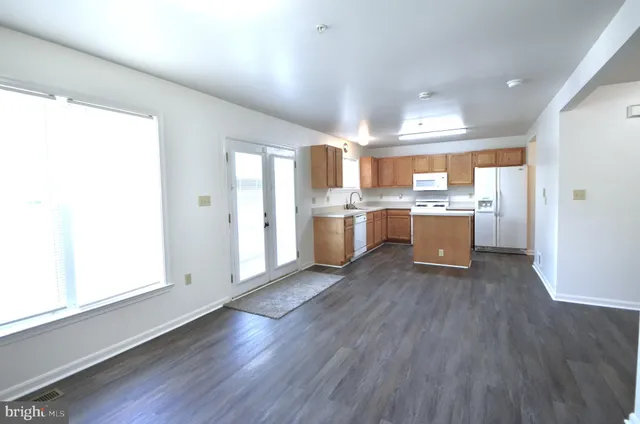 a kitchen with stainless steel appliances granite countertop a stove and a refrigerator