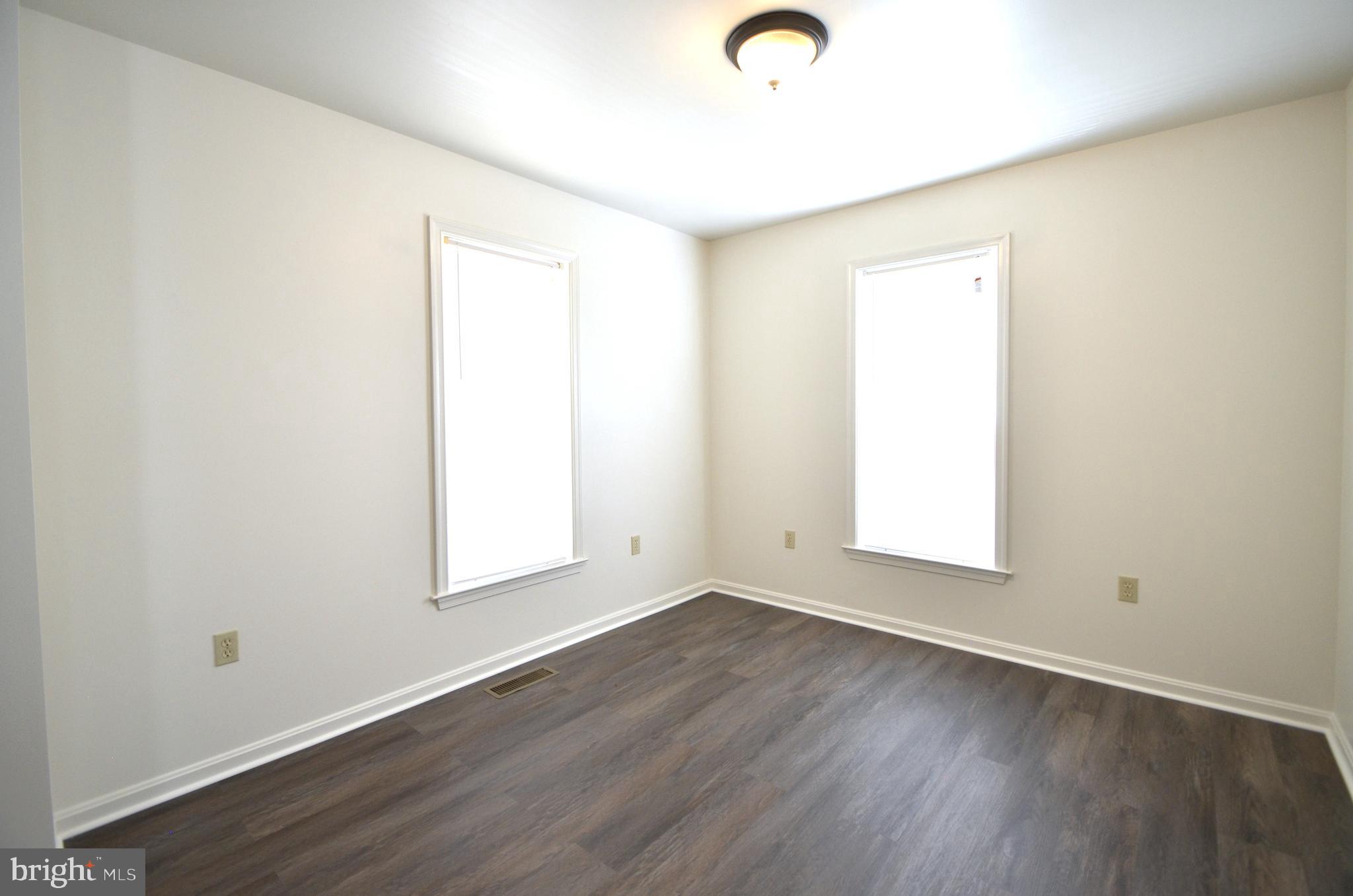 4 Ridge Road Southeast Washington, DC 20019 - Photo 17 of 47 an empty room with wooden floor and windows