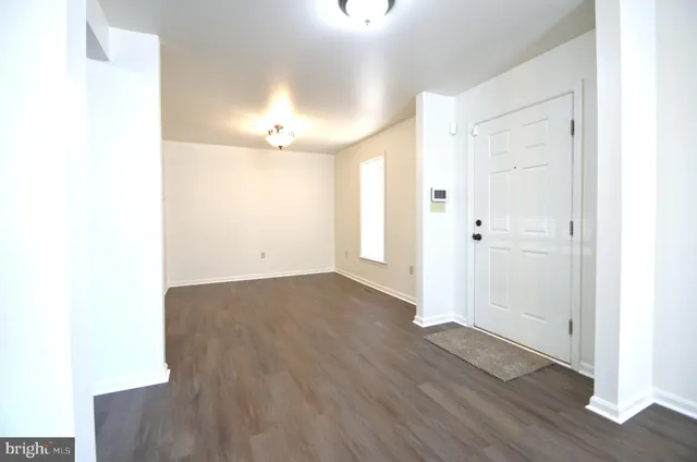a view of a room with wooden floor