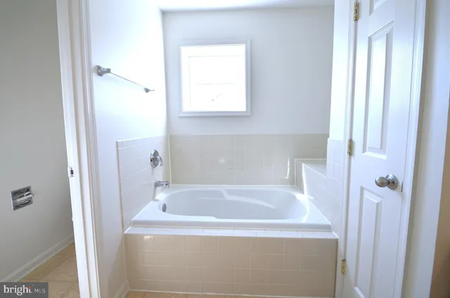 a white bath tub sitting next to a window