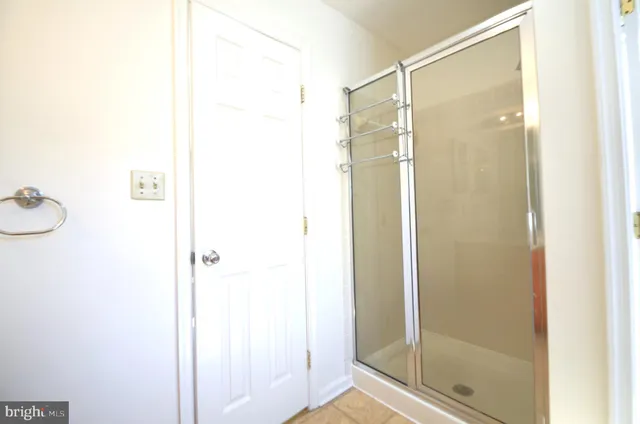 a bathroom with a shower and a glass door